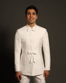 A model wears a designer white dagli featuring motif embroidery made by Parsi bespoke designer Kaizad Wadia (Photo: Instagram) A model wears a designer white dagli featuring motif embroidery made by Parsi bespoke designer Kaizad Wadia (Photo: Instagram)