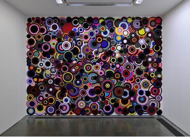 Kher’s The Nemesis of Nations (2008) blows bindis up to create an abstract work. Kher’s The Nemesis of Nations (2008) blows bindis up to create an abstract work.