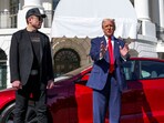 US President Donald Trump talks to the media next to Tesla CEO Elon Musk