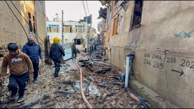 Locals near the houses gutted in fire that broke out in a residential area, in the Kadipora locality of Anantnag district. (PTI) Locals near the houses gutted in fire that broke out in a residential area, in the Kadipora locality of Anantnag district. (PTI)