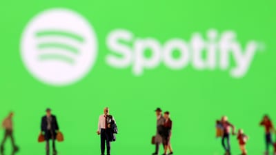 Small figurines are seen in front of displayed Spotify logo in this illustration taken February 11, 2022. (Dado Ruvic/Reuters)