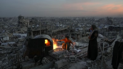 Ali Marouf and his mother Aisha cook on a fire on the roof of their house, which was destroyed by the Israeli army's air and ground offensive, in Jabaliya, Gaza Strip. (AP) Ali Marouf and his mother Aisha cook on a fire on the roof of their house, which was destroyed by the Israeli army's air and ground offensive, in Jabaliya, Gaza Strip. (AP)