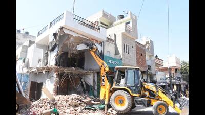 The illegal building constructed by three brothers, who are in jail for smuggling drugs, being demolished in Jalandhar on Friday. (HT Photo) The illegal building constructed by three brothers, who are in jail for smuggling drugs, being demolished in Jalandhar on Friday. (HT Photo)
