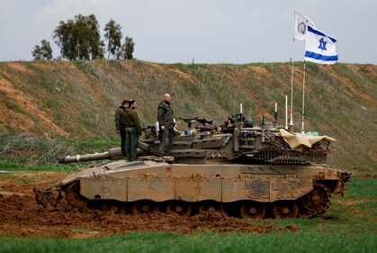 Israeli soldiers stand on a tank on the Israeli side of the border with Gaza, amid a ceasefire between Israel and Hamas, as seen from Israel, February 11, 2025. (Reuters)