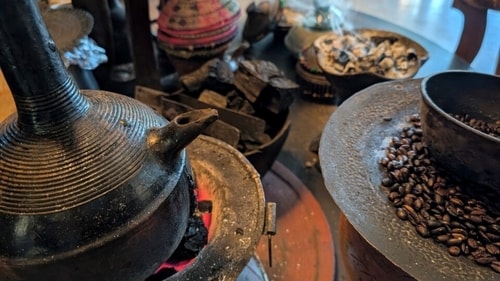 Freshly roasted coffee beans and burning incense surround a traditional clay pot, or jebena, during a coffee ceremony at a hotel in Addis Ababa. (AP) Freshly roasted coffee beans and burning incense surround a traditional clay pot, or jebena, during a coffee ceremony at a hotel in Addis Ababa. (AP)