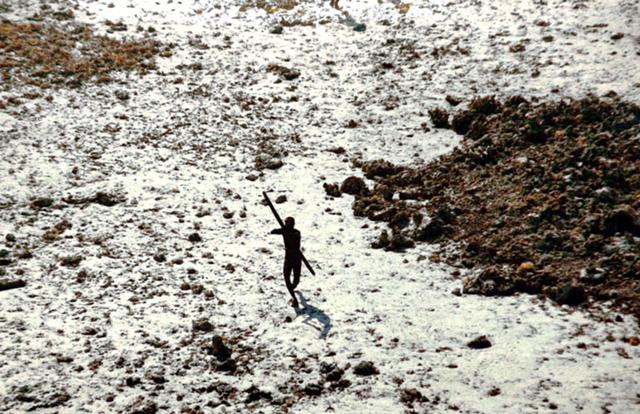 A Sentinelese man aims an arrow at a Coast Guard helicopter. (Courtesy Survival International) A Sentinelese man aims an arrow at a Coast Guard helicopter. (Courtesy Survival International)