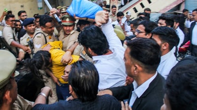 Police intervene as lawyers trash accused Sahil Shukla while he was being produced in a court in connection with Merchant Navy officer Saurabh Rajput's killing, in Meerut, Wednesday, March 19, 2025. Muskan with Sahil allegedly killed her husband Saurabh, dismembered his body, and sealed the body parts in a drum filled with cement. (PTI) Police intervene as lawyers trash accused Sahil Shukla while he was being produced in a court in connection with Merchant Navy officer Saurabh Rajput's killing, in Meerut, Wednesday, March 19, 2025. Muskan with Sahil allegedly killed her husband Saurabh, dismembered his body, and sealed the body parts in a drum filled with cement. (PTI)