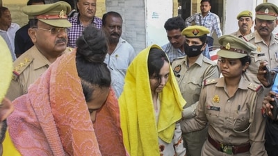 Police take away Merchant Navy officer Saurabh Rajput's wife Muskaan and her lover Sahil Shukla after they were arrested in connection with his murder, in Meerut, on March 19, 2025. (PTI)