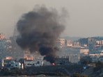 Smoke rises from a burning building in North Gaza, as seen from the Israel-Gaza border, March 23, 2025. 