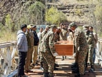 Indian Army officials facilitate the return of the mortal remains of two missing youths from Pakistan-Occupied Kashmir (POJK), at Uri in Baramulla on Saturday. Indian Army officials facilitate the return of the mortal remains of two missing youths from Pakistan-Occupied Kashmir (POJK), at Uri in Baramulla on Saturday.