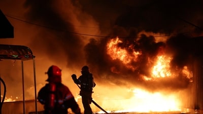 Firefighters extinguish a fire at a factory building that has been engulfed in a wildfire in South Korea (AP) Firefighters extinguish a fire at a factory building that has been engulfed in a wildfire in South Korea (AP)