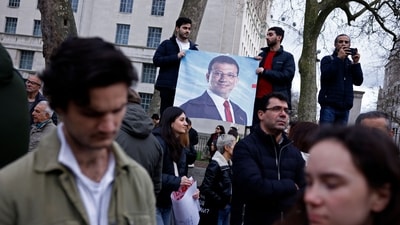 Protesters hold placards flags as they attend a rally in support of Istanbul's arrested mayor, in central London on March 22, 2025. (AFP) Protesters hold placards flags as they attend a rally in support of Istanbul's arrested mayor, in central London on March 22, 2025. (AFP)