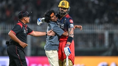 Virat Kohli embraces a fan who ran onto the pitch at the Eden Gardens in the KKR vs RCB match. (AFP) Virat Kohli embraces a fan who ran onto the pitch at the Eden Gardens in the KKR vs RCB match. (AFP)