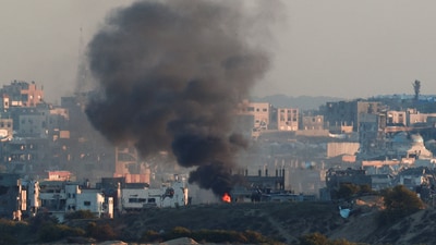 Smoke rises from a burning building in North Gaza, as seen from the Israel-Gaza border, March 23, 2025. (REUTERS)