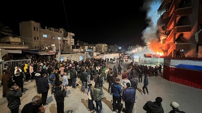 People gather as smoke rises following an Israeli airstrike at Nasser hospital, according to the Palestinian civil defence, in Khan Younis in the southern Gaza Strip March 23, 2025. (REUTERS)