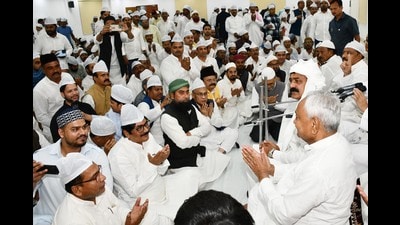 Bihar chief minister Nitish Kumar with Muslim attendees during an Iftar party hosted at 1, Anne Marg in Patna, on Sunday. (Santosh Kumar/HT)
