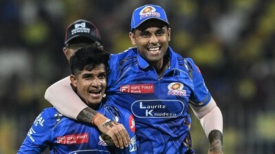 Vignesh Puthur (L) with captain Suryakumar Yadav celebrating a wicket (AFP) Vignesh Puthur (L) with captain Suryakumar Yadav celebrating a wicket (AFP)