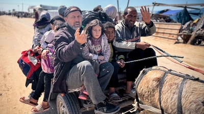 Palestinians set out to Khan Yunis with their belongings, from Rafah's Tel al-Sultan area after it was encircled by Israeli forces. (AFP) Palestinians set out to Khan Yunis with their belongings, from Rafah's Tel al-Sultan area after it was encircled by Israeli forces. (AFP)