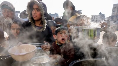 Children hold out empty pots as they queue for charity meals handed out from a kitchen during the Muslim holy fasting month of Ramadan, in Gaza City. (AFP) Children hold out empty pots as they queue for charity meals handed out from a kitchen during the Muslim holy fasting month of Ramadan, in Gaza City. (AFP)