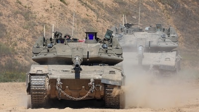 An Israeli soldier operates a tank at a position along Israel's southern border with the northern Gaza Strip. (AFP) An Israeli soldier operates a tank at a position along Israel's southern border with the northern Gaza Strip. (AFP)