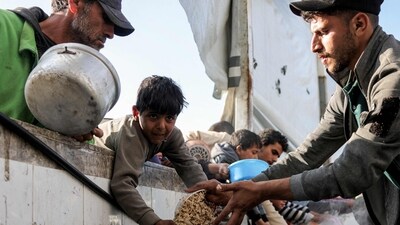 Children hold out empty pots as they queue for charity meals handed out from a kitchen during the Muslim holy fasting month of Ramadan, in Gaza City on March 22, 2025. (AFP) Children hold out empty pots as they queue for charity meals handed out from a kitchen during the Muslim holy fasting month of Ramadan, in Gaza City on March 22, 2025. (AFP)