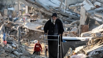 An elderly man moves with a walker past rubble along a broken road as people displaced by conflict from Beit Lahia arrive in Gaza City on March 22, 2025. (AFP) An elderly man moves with a walker past rubble along a broken road as people displaced by conflict from Beit Lahia arrive in Gaza City on March 22, 2025. (AFP)