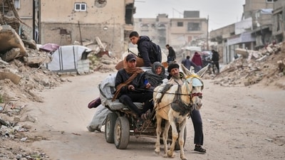 Displaced Palestinians, carrying their belongings, move away from the areas where the Israeli army is operating after Israel's renewed offensive in the Gaza Strip, in Khan Younis. (AP) Displaced Palestinians, carrying their belongings, move away from the areas where the Israeli army is operating after Israel's renewed offensive in the Gaza Strip, in Khan Younis. (AP)