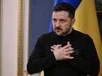 Ukrainian President Volodymyr Zelensky gestures as he speaks to journalists during his press conference in Kyiv.