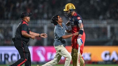 A fan (C) of Royal Challengers Bengaluru's Virat Kohli (R) had entered the pitch to hug him during IPL 2025 match against Kolkata Knight Riders (AFP) A fan (C) of Royal Challengers Bengaluru's Virat Kohli (R) had entered the pitch to hug him during IPL 2025 match against Kolkata Knight Riders (AFP)