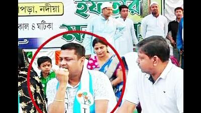 In this image, we can see the West Bengal police officer wearing a TMC scarf at an Iftar party. In this image, we can see the West Bengal police officer wearing a TMC scarf at an Iftar party.