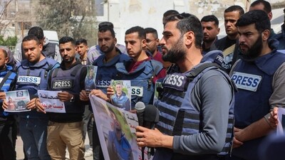 Palestinian journalists lift placards during a rally in protest of the killing of fellow reporters Hussam Shabat and Muhammad Mansour. (AFP) Palestinian journalists lift placards during a rally in protest of the killing of fellow reporters Hussam Shabat and Muhammad Mansour. (AFP)