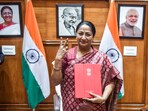Chief minister Rekha Gupta poses with the Delhi Budget document at her office on Tuesday.(ANI Photo)