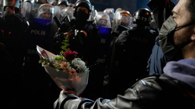 A protester offers flowers to riot police during a protest after Istanbul's Mayor Ekrem Imamoglu was arrested and sent to prison, in Istanbul, Turkey, Tuesday.  (AP)