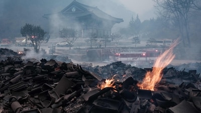 One of the victims was a pilot whose helicopter crashed in the southeast town of Uiseong, one of the most severely affected locations, while he was fighting flames. In pic: Embers remain among the debris after most of the buildings were burned to the ground in a wildfire at Gounsa Temple in Uiseong, South Korea. (AFP) One of the victims was a pilot whose helicopter crashed in the southeast town of Uiseong, one of the most severely affected locations, while he was fighting flames. In pic: Embers remain among the debris after most of the buildings were burned to the ground in a wildfire at Gounsa Temple in Uiseong, South Korea. (AFP)