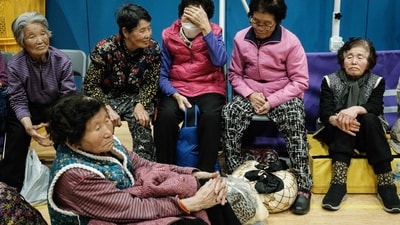 People evacuated from their homes due to the approaching wildfire stay at the gymnasium of Sinsung Elementary School in Andong, South Korea, on March 25, 2025. Inhabitants of a UNESCO-listed village were ordered to evacuate while a historic Buddhist temple was burned to the ground as South Korea scrambled to contain worsening wildfires, which are tearing across the country's southeast. (AFP) People evacuated from their homes due to the approaching wildfire stay at the gymnasium of Sinsung Elementary School in Andong, South Korea, on March 25, 2025. Inhabitants of a UNESCO-listed village were ordered to evacuate while a historic Buddhist temple was burned to the ground as South Korea scrambled to contain worsening wildfires, which are tearing across the country's southeast. (AFP)
