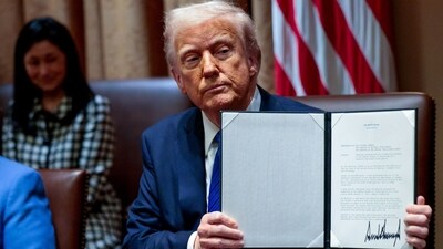 US President Donald Trump displays a signed executive order during a meeting with US ambassadors in the Cabinet Room of the White House in Washington, DC, US, on Tuesday, March 25, 2025. (Bloomberg) US President Donald Trump displays a signed executive order during a meeting with US ambassadors in the Cabinet Room of the White House in Washington, DC, US, on Tuesday, March 25, 2025. (Bloomberg)