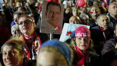 At least seven journalists, including AFP photographer Yasin Akgul, have been imprisoned for their coverage of the protests. Strongly condemning Akgul's detention, Paris-based Agence France-Presse claims he was only recording the events and wasn't taking part in the protests. In pic: Protesters hold a picture of Istanbul's Mayor Ekrem Imamoglu during a protest after he was arrested and sent to prison, in Istanbul, Turkey.  (AP)