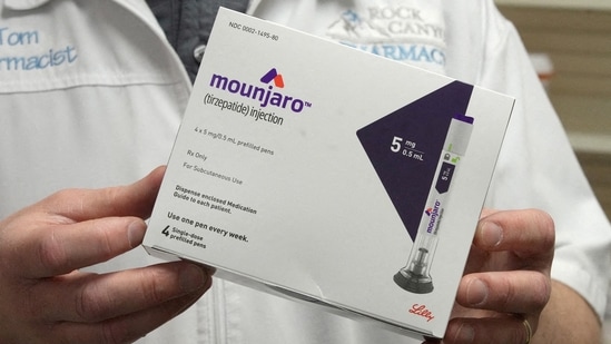 A pharmacist displays a box of Mounjaro, a tirzepatide injection drug used for treating type 2 diabetes in the US on March 29, 2023. (File Photo/REUTERS)