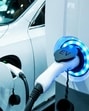 Power supply connect to electric vehicle for charge to the battery. Charging technology industry transport which are the futuristic of the Automobile. EV fuel Plug in hybrid car. (Shutterstock)