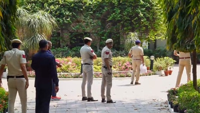 A Delhi Police team at the residence of Delhi high court judge Justice Yashwant Varma in New Delhi. (PTI)