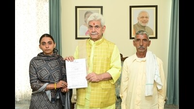 J&K Lieutenant Governor Manoj Sinha, on Thursday, handed over the appointment letter, on compassionate ground, to Renu Sharma, sister of Arjun Sharma, who was killed in Reasi terror attack on June 9 last year. (HT Photo)