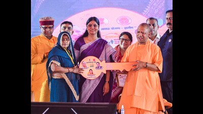 UP CM Yogi Adityanath with MoS Anupriya Patel felicitates a beneficiary during a program on the completion of eight years of the state government, in Mirzapur on Thursday (PTI) UP CM Yogi Adityanath with MoS Anupriya Patel felicitates a beneficiary during a program on the completion of eight years of the state government, in Mirzapur on Thursday (PTI)