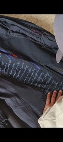 The outfit features the names of the people who lost their lives in the ethnic riot. The outfit features the names of the people who lost their lives in the ethnic riot.
