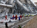 Rescue personnel work near a building in Bangkok that collapsed after a strong earthquake struck central Myanmar on Friday