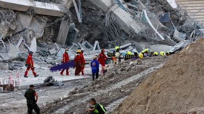 Rescue personnel work near a building in Bangkok that collapsed after a strong earthquake struck central Myanmar on Friday (Reuters)