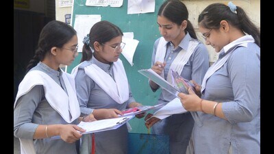 Class 12 students discussing question paper after coming out of examination centre in Ludhiana on Friday. (Gurpreet Singh/HT)