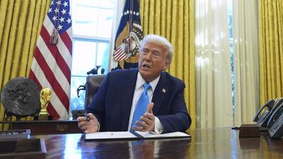 FILE - President Donald Trump speaks to reporters as he signs executive orders in the White House. (AP) FILE - President Donald Trump speaks to reporters as he signs executive orders in the White House. (AP)