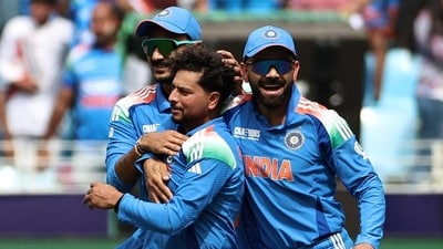 Kuldeep Yadav celebrating a wicket during Champions Trophy with Axar Patel (L) and Virat Kohli (AFP) Kuldeep Yadav celebrating a wicket during Champions Trophy with Axar Patel (L) and Virat Kohli (AFP)