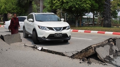 A car attempts to drive along a damaged road in Naypyidaw on March 28, 2025, after an earthquake in central Myanmar. (AFP) A car attempts to drive along a damaged road in Naypyidaw on March 28, 2025, after an earthquake in central Myanmar. (AFP)