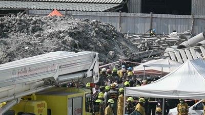 Rescue workers stand near the debris of a construction site after a building collapsed in Bangkok on March 28, 2025, following an earthquake. (AFP) Rescue workers stand near the debris of a construction site after a building collapsed in Bangkok on March 28, 2025, following an earthquake. (AFP)